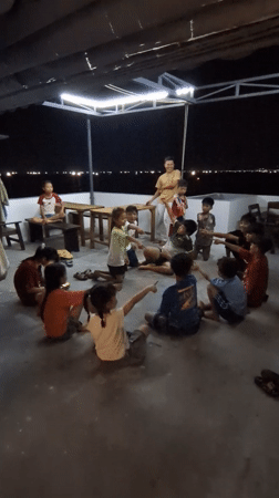 Children gather under supervision in Phan Rang patio area