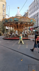 Antique carousel operates in Toulouse square during evening hours