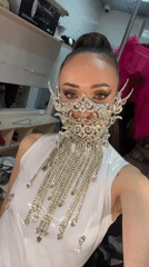 Woman takes masked selfies in ornate silver face covering