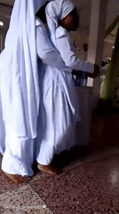 Women in white robes gather for religious ceremony in Lagos