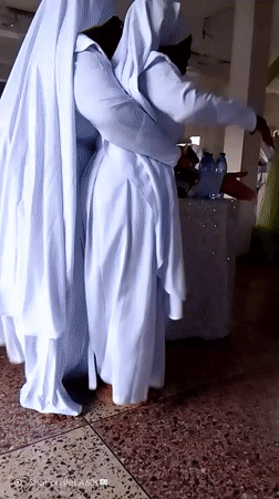 Women in white robes gather for religious ceremony in Lagos