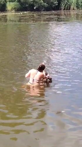 Muddy summer swim at a Ukrainian riverside, July 2026
