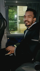 Passenger smiles at camera during night bus ride in Morocco
