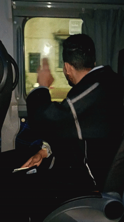 Passenger smiles at camera during night bus ride in Morocco