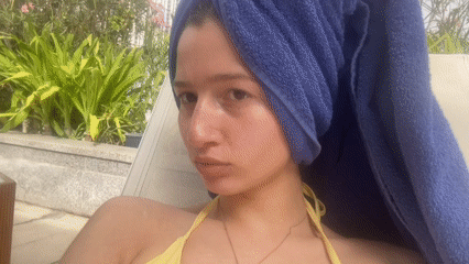 Woman relaxes poolside in Dubai's Business Bay district