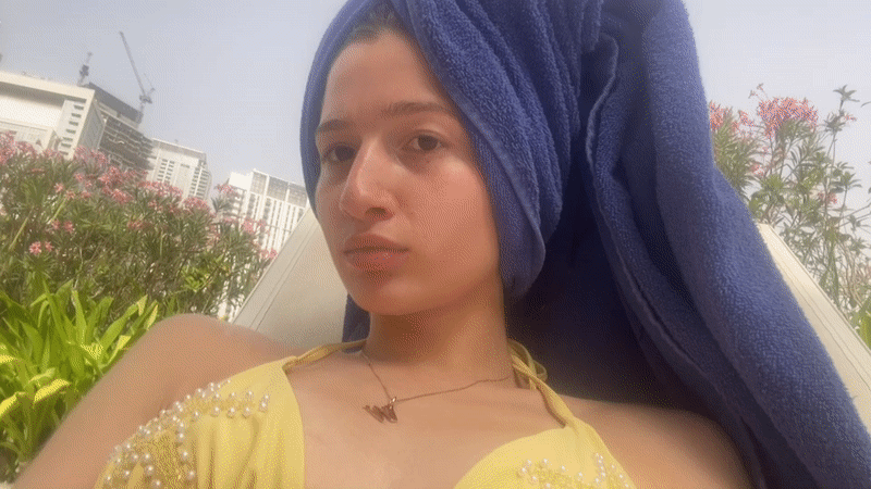 Woman relaxes poolside in Dubai's Business Bay district
