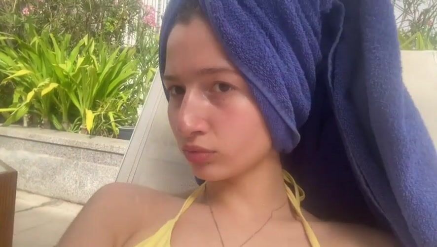 Woman relaxes poolside in Dubai's Business Bay district