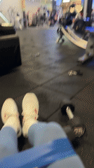 Woman documents gym workout session with exercise equipment