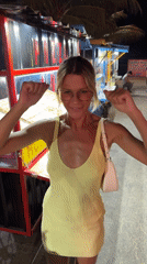 Woman dances near food stand in North Kuta