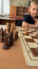 Chess game captured up close, one player visibly thinking hard