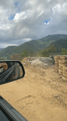 Rural Vietnam construction site, cow crossing road documented