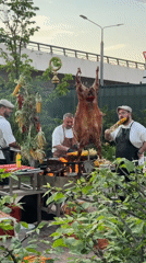Outdoor cooking event features roasted meat, coffee service