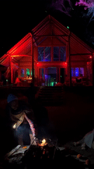Colorful lights illuminate building and tree in Kintamani