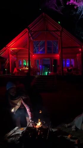 Colorful lights illuminate building and tree in Kintamani