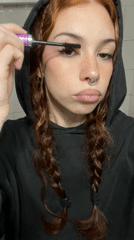 Woman applies makeup late night in Buenos Aires