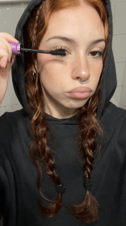 Woman applies makeup late night in Buenos Aires