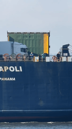Cargo ship passes anglers fishing from Varna shoreline