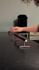 Person performs fingerboard tricks on railing in Yekaterinburg