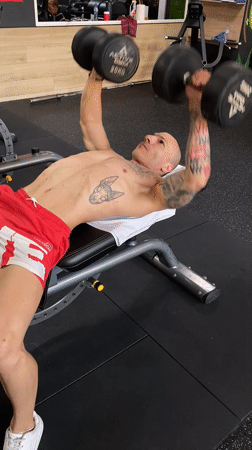 Tattooed man works out at Pleven gym early morning