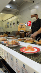 Morning sushi dining captured at Busan conveyor belt restaurant