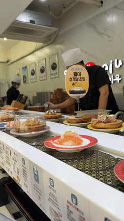 Morning sushi dining captured at Busan conveyor belt restaurant