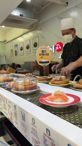 Morning sushi dining captured at Busan conveyor belt restaurant