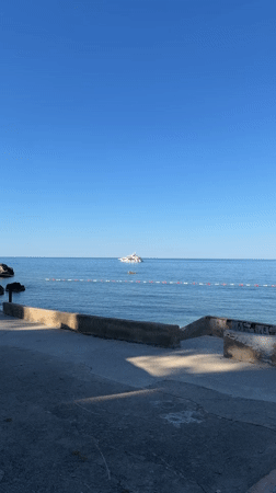 Yacht anchored off Montenegro coast under clear skies