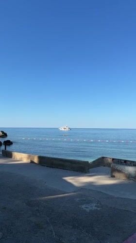 Yacht anchored off Montenegro coast under clear skies