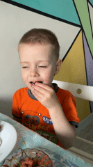 Children play indoors and outdoors during overcast afternoon
