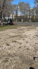 Young men use playground equipment in spring park setting