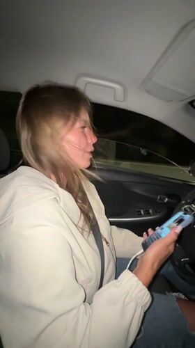 Young women film selfie video during nighttime drive in Montenegro