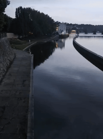 Evening riverfront activity documented across central Prague
