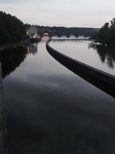 Evening riverfront activity documented across central Prague