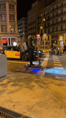 Emergency vehicles with flashing lights patrol Barcelona streets at night