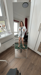Woman records herself dancing in bedroom mirror