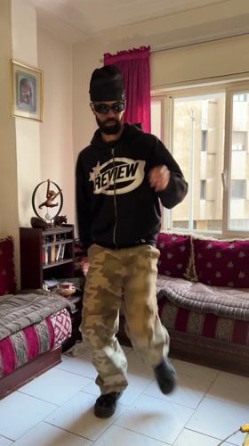 Man dances and smokes in Tangier apartment during morning hours