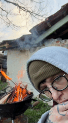 Person grills sausages at outdoor barbecue in Karlukovo, Bulgaria