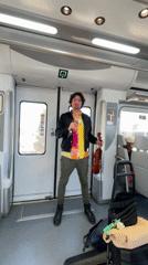 Street musician performs with violin aboard Barcelona train