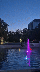 Color-lit fountain display at dusk in Popovo park