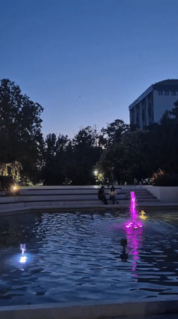 Color-lit fountain display at dusk in Popovo park