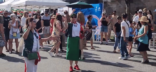Italian-themed street festival with food vendors and crowds