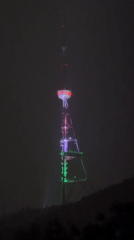 Rainy evening scenes captured around illuminated Tbilisi broadcasting tower