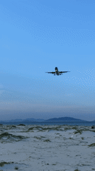 Plane on final approach over Cam Ranh's coastal shoreline