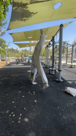Woman performs cartwheel at Givatayim outdoor exercise park