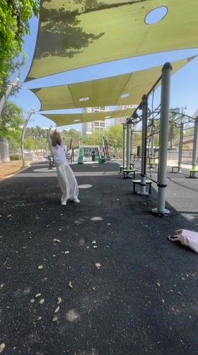 Woman performs cartwheel at Givatayim outdoor exercise park