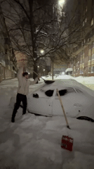 Kazan resident digs car from snow during winter evening