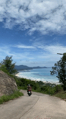 Motorcycle journey documented through coastal Thai village roads and landscapes