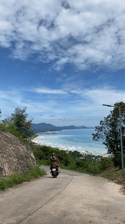 Motorcycle journey documented through coastal Thai village roads and landscapes