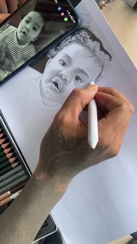 Artist creates baby portrait using phone photo reference in Kuta