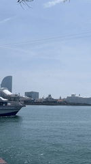Tour boat crosses Barcelona harbor on sunny Wednesday morning
